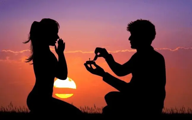 Como surgiu a tradição das alianças de casamento? - homem-pedindo-mulher-em-casamento-ao-por-do-sol