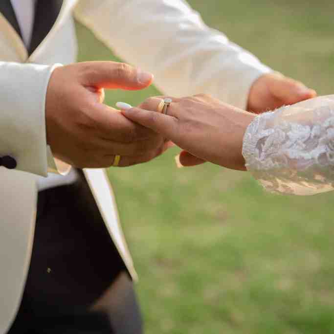 Homem segurando mão da noiva