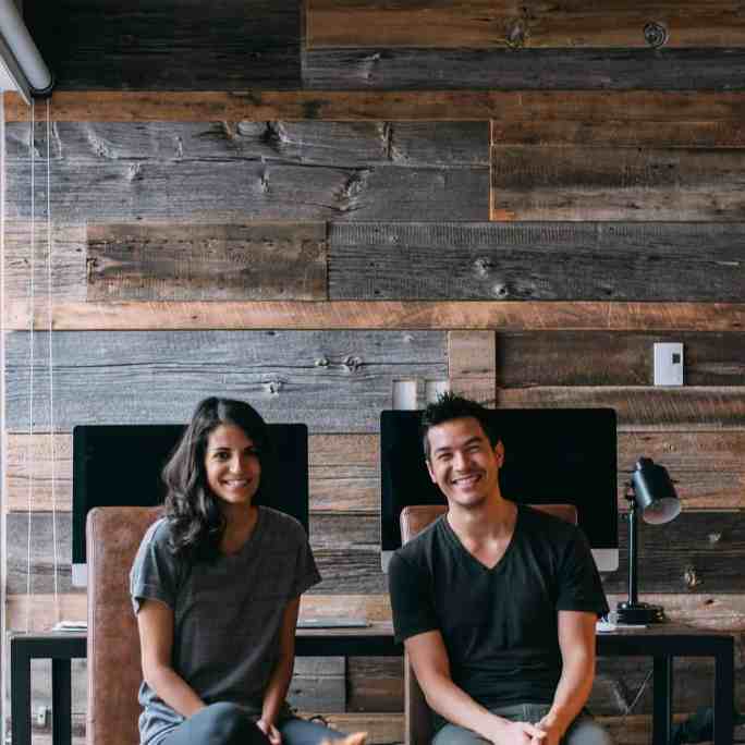 Como adotar um pet pode ajudar no seu relacionamento? - Pet donos relacionamento 3 Casal sentado em cadeiras e um cachorro na frente deles