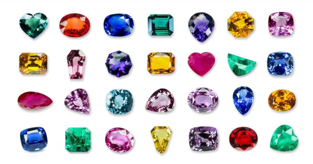 Imagem de fundo branco com diversas pedras em cores diferentes - psicologia das cores em pedras preciosas